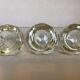Set of three thick moulded glass candle holders.