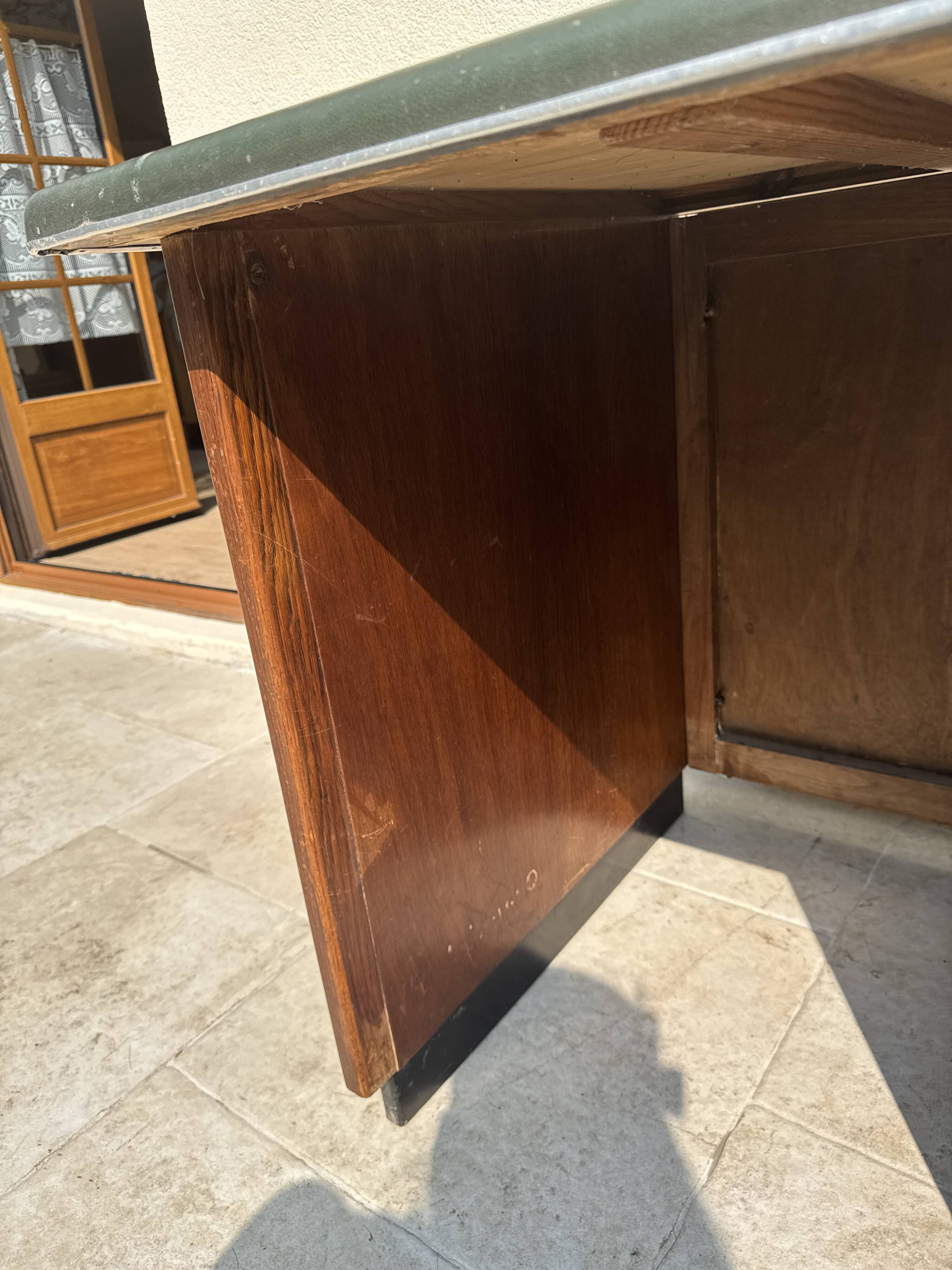 Modernist desk in wood and green moleskin upholstery
