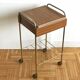 Serving bedside in gold metal and formica