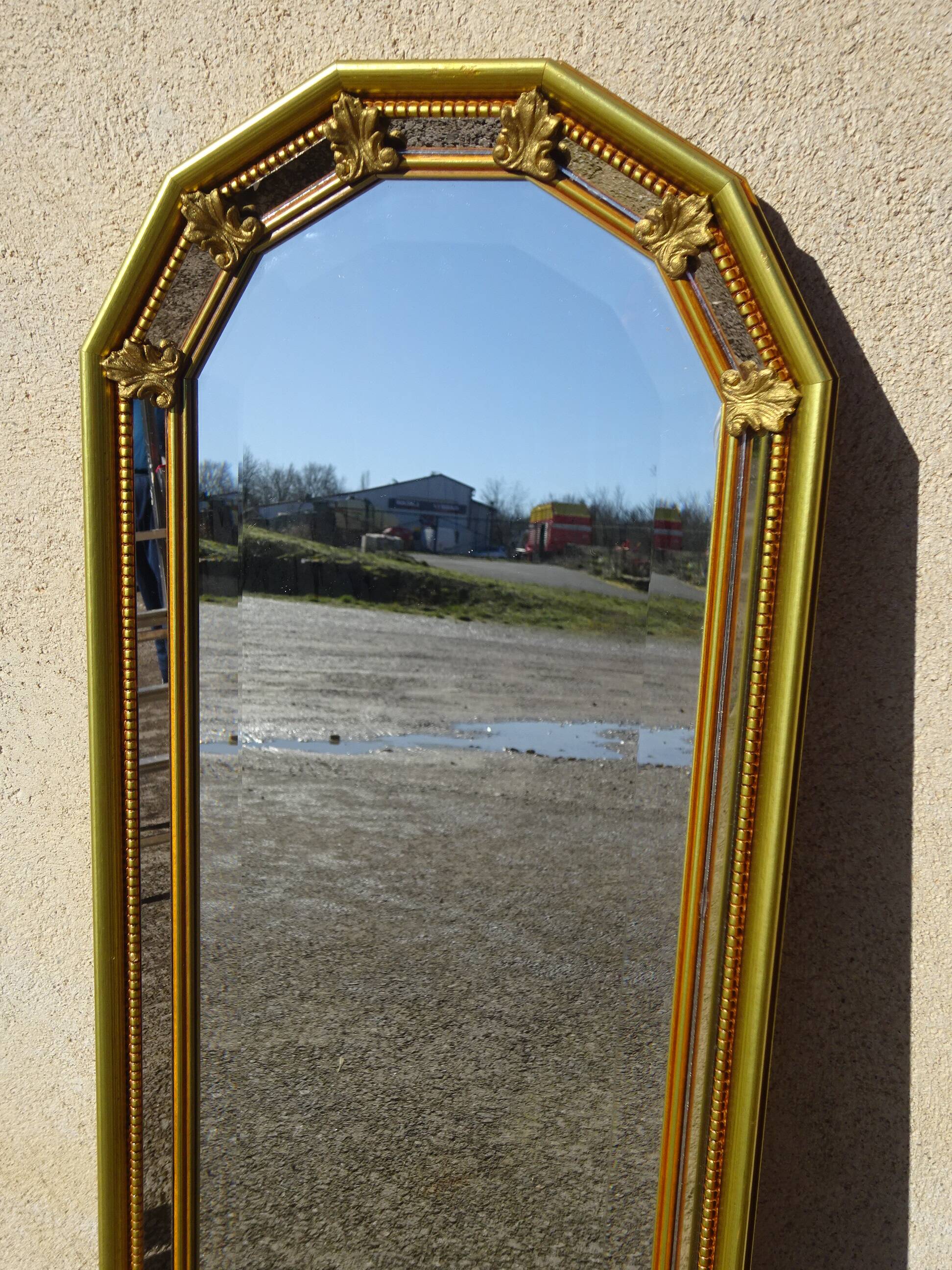 Hall mirror, gilded frame with fillets and fleur-de-lis.