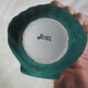 Porcelain pocket tray in the shape of a golden scallop shell with duck green background from the 50s/60s