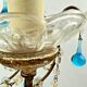 Italian chandelier with blue beads and gilded wood.