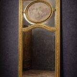 Very large mirror with mouldings, richly carved and gilded, in the Louis XVI style.