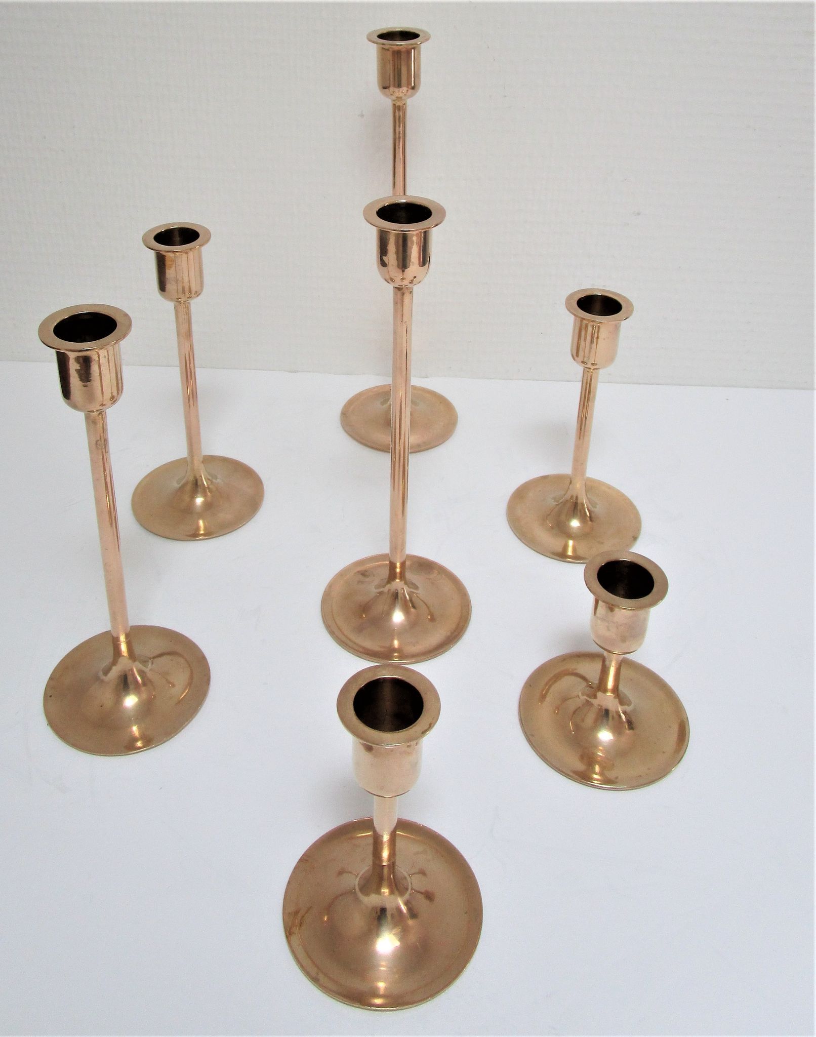 Series of seven candle holders solid brass