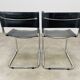 Paire de chaises cantilever simili cuir noir et chrome
