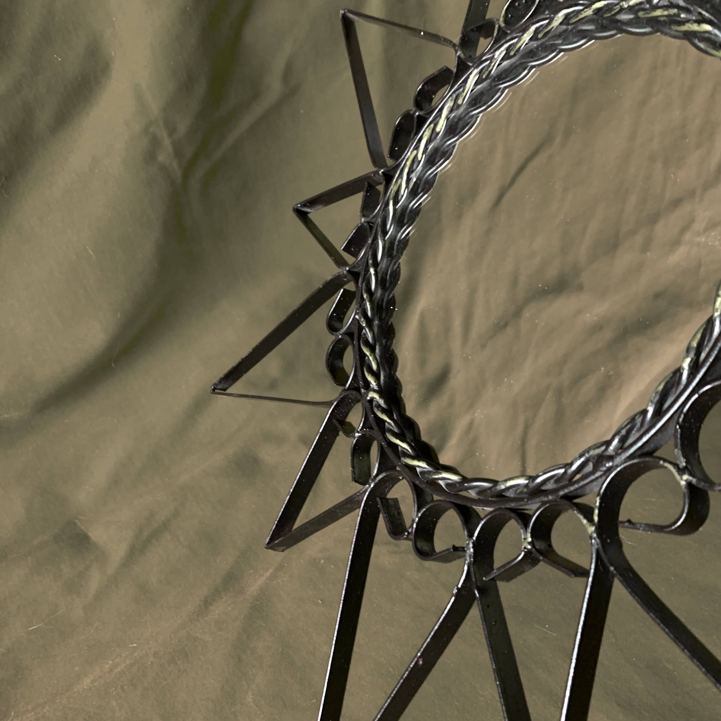 Old wrought metal sun mirror