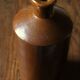 Vintage Bourne Deney stoneware liqueur bottle with pouring spout.