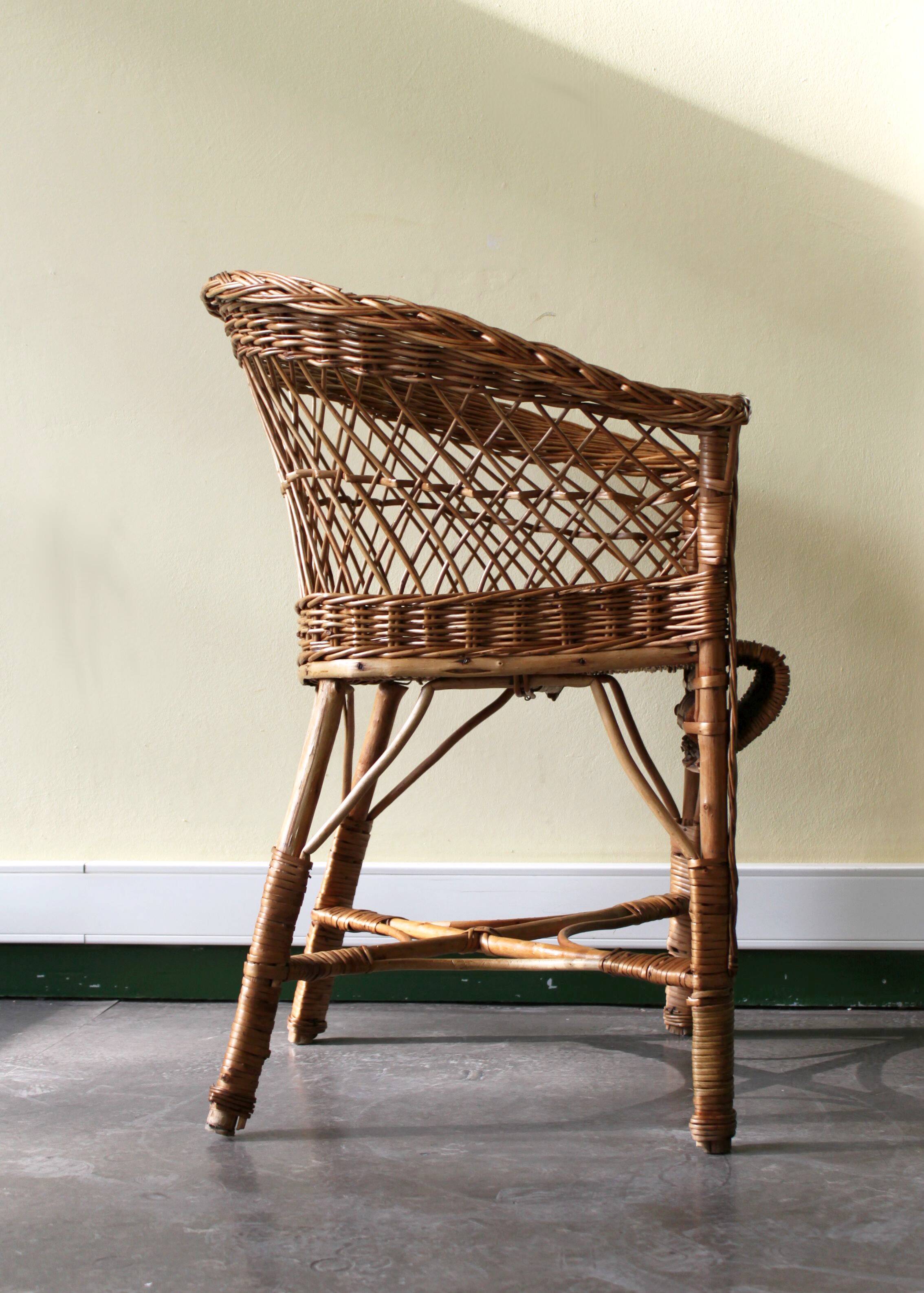 Woven rattan armchair with armrests.