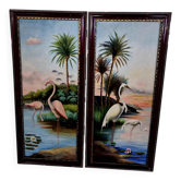 Paire de peintures à l’huile sur toile représentant des oiseaux tropicaux