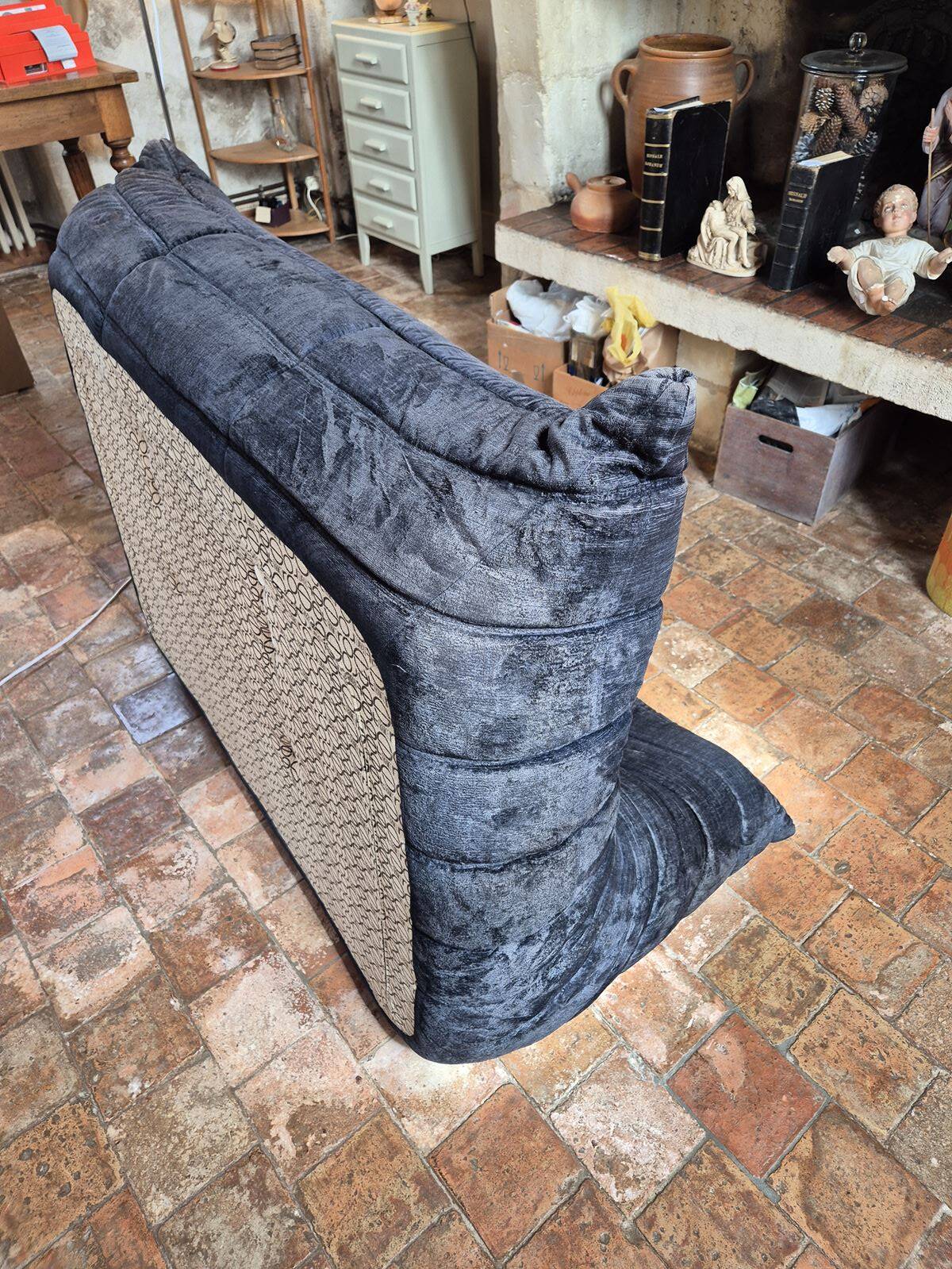 Togo sofa by Ligne Roset and its pouf from the 1970s.