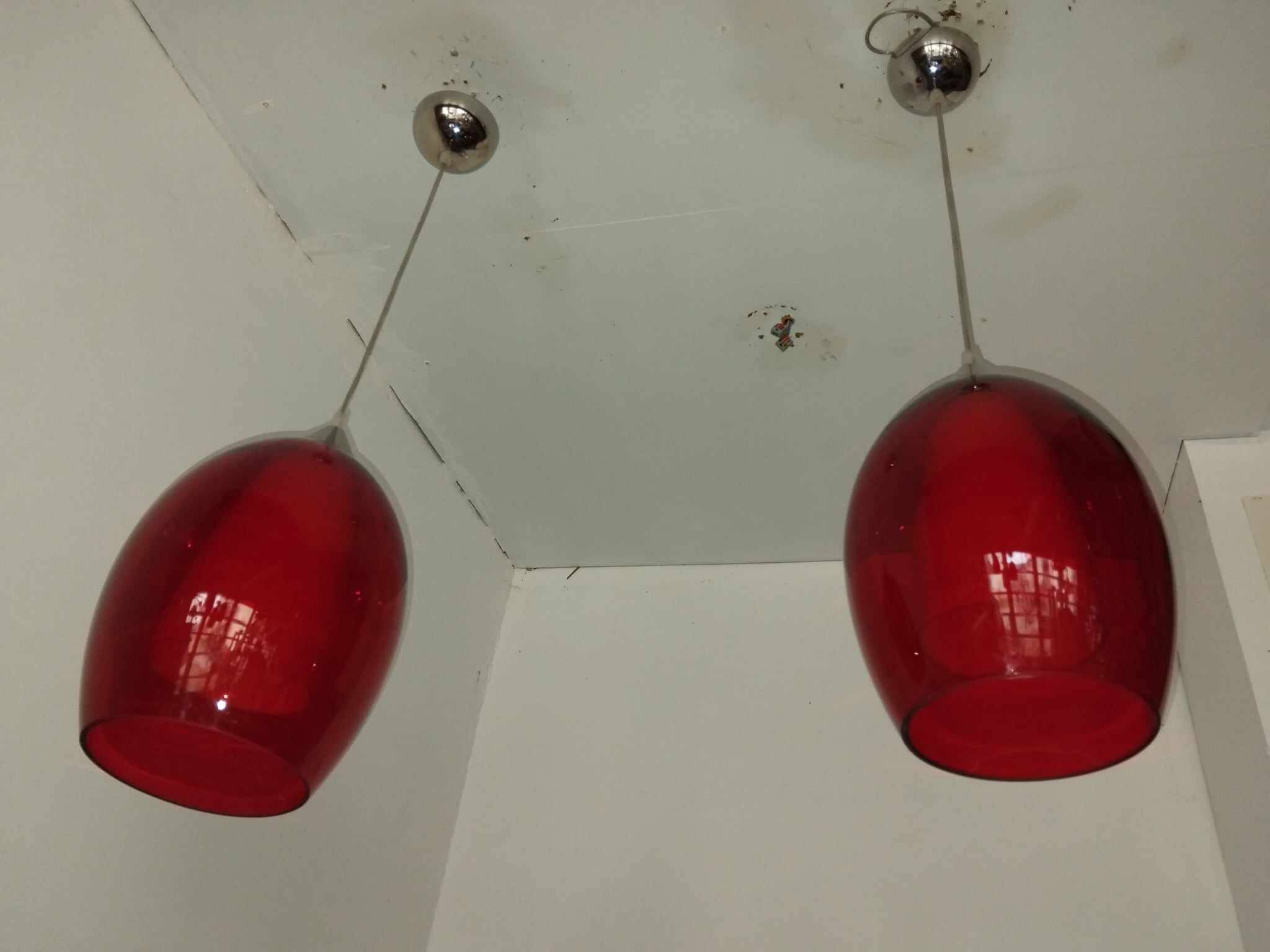 Pair of conical pendant lights in red tinted glass