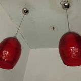 Pair of conical pendant lights in red tinted glass