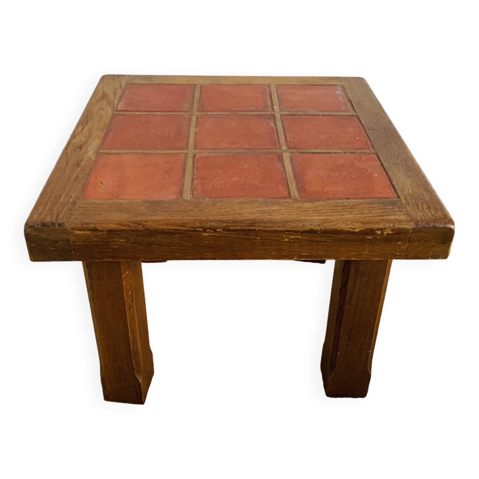 Square table with red tiles signed.
