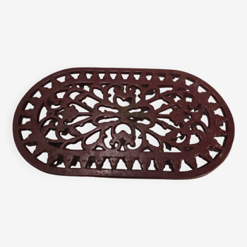 Vintage oval dark red cast iron trivet