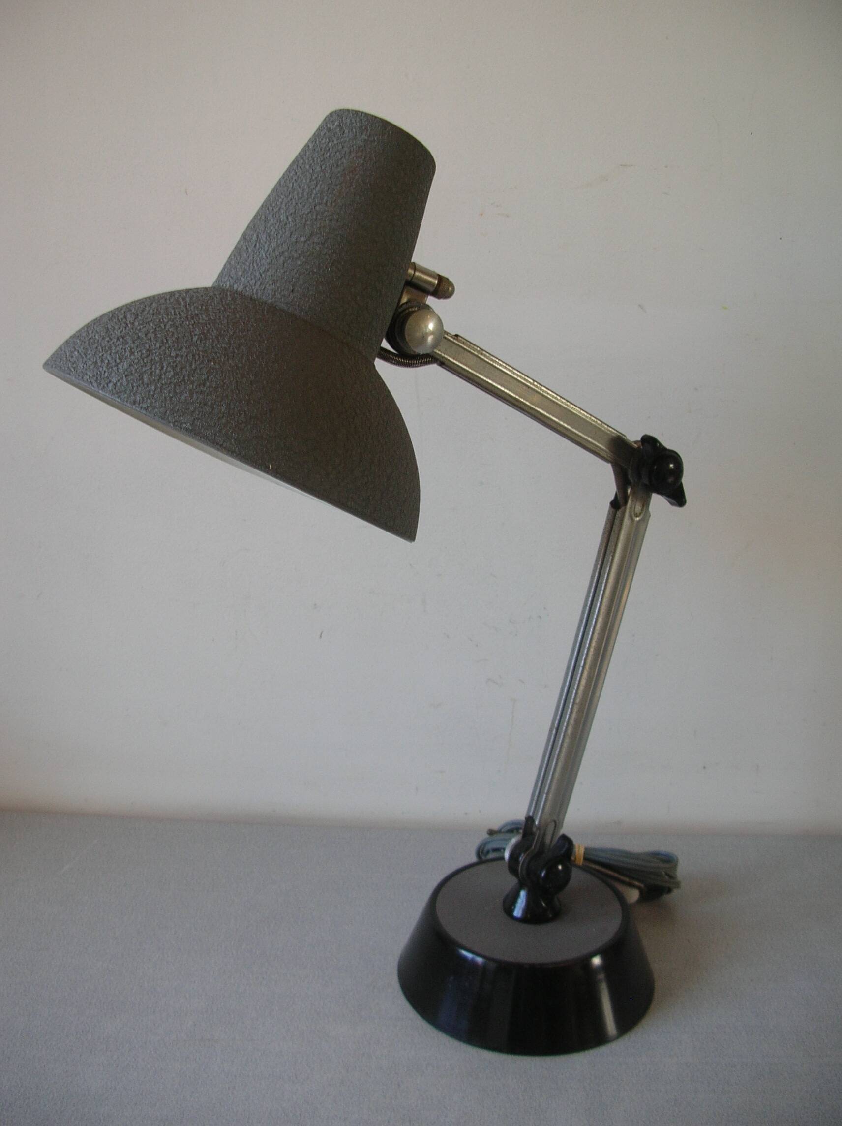 Super Chrome old articulated metal desk lamp on workshop decor base