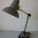 Super Chrome old articulated metal desk lamp on workshop decor base