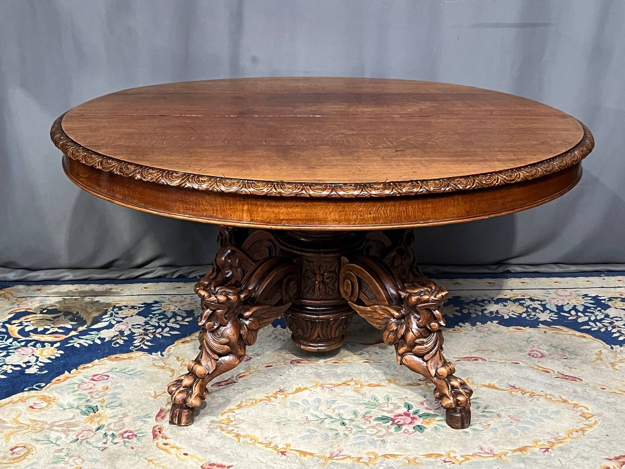 Large extendable dining table in hunting style with four fox figures on the leg.