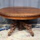 Large extendable dining table in hunting style with four fox figures on the leg.