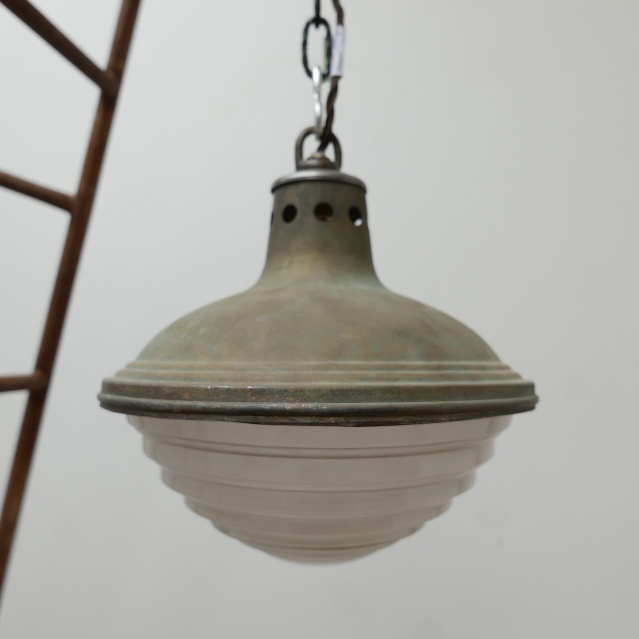 Patinated metal and glass Holophane pendant light