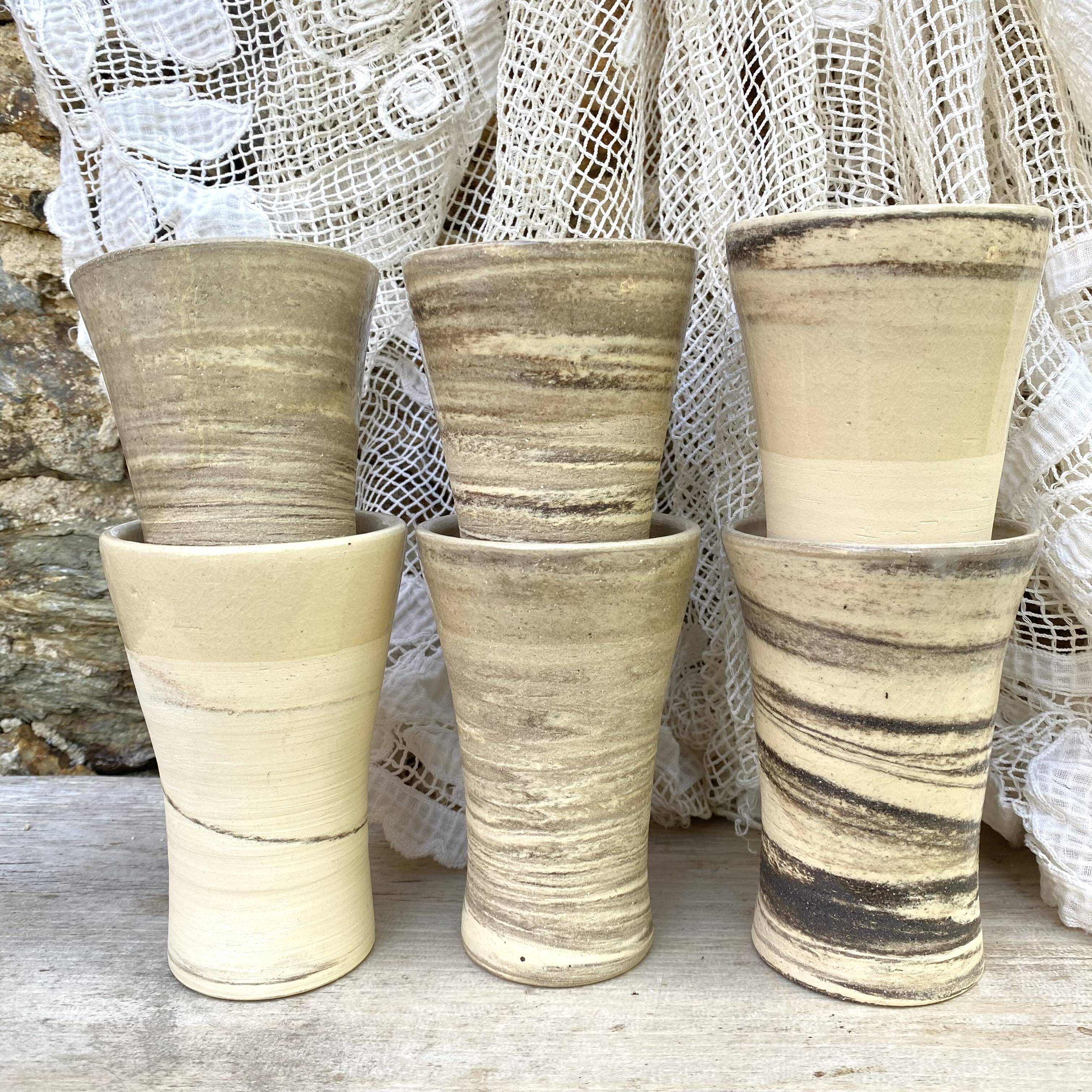 High ceramic cups made of mixed clay.