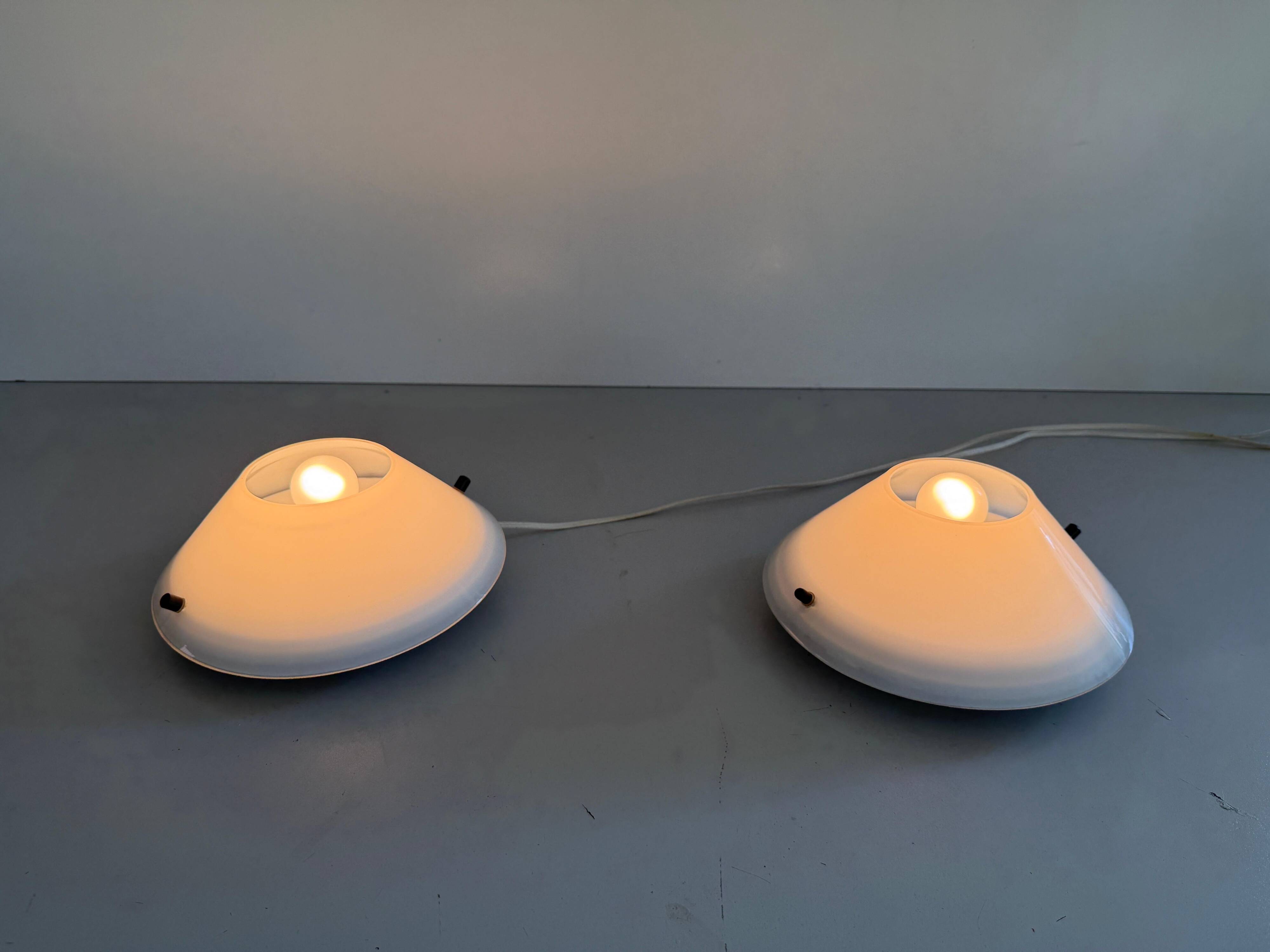 Pair of opal glass wall lights from the mid-century by Lamperti, 1960s, Italy.