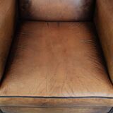 Large and comfortable sheepskin leather wingback chair with black piping