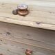 Victorian commode from the 19th century stripped to raw solid wood with ceramic knobs.