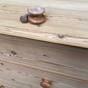 Victorian commode from the 19th century stripped to raw solid wood with ceramic knobs.