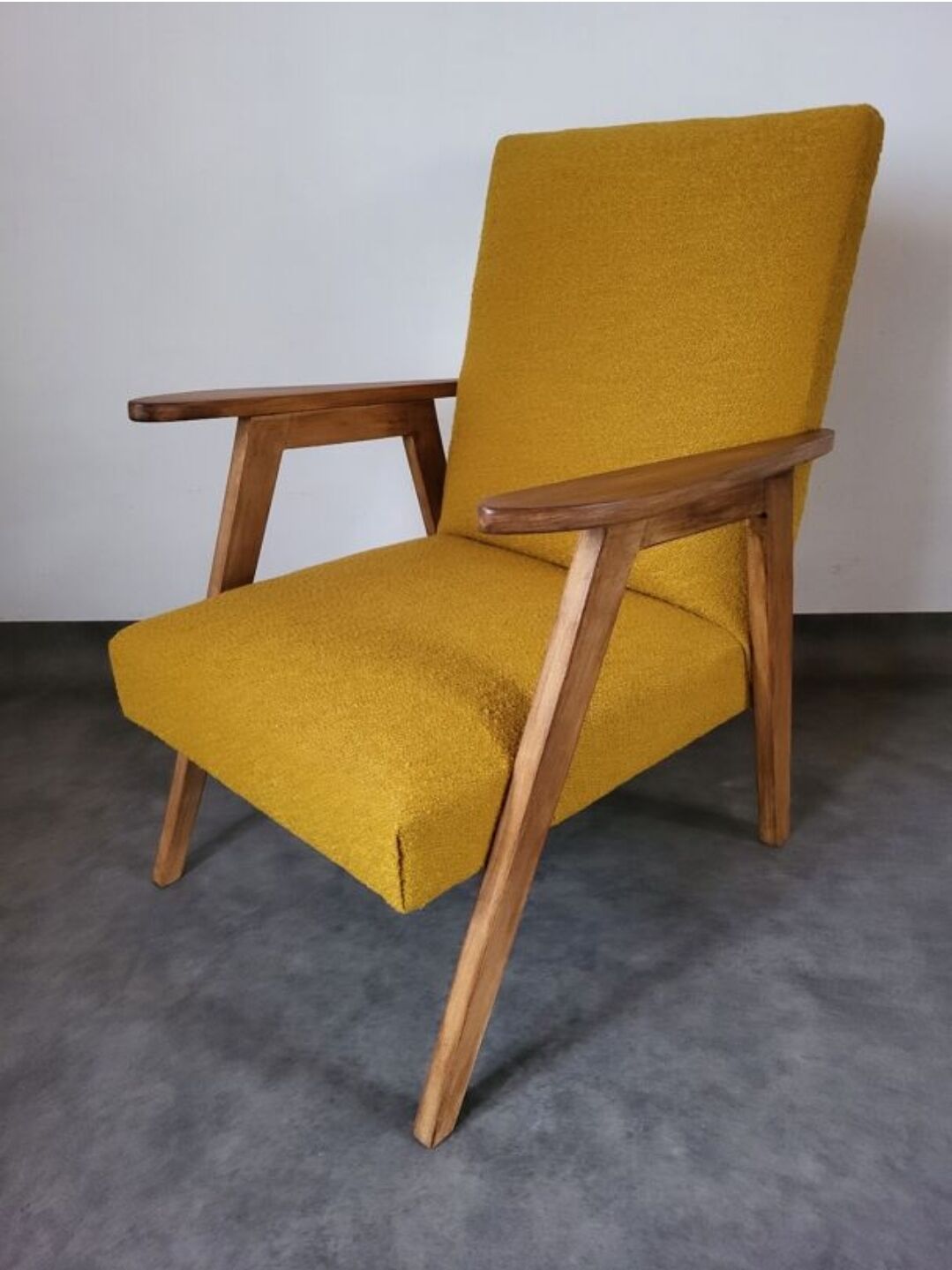 Curly yellow Scandinavian armchair