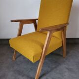 Curly yellow Scandinavian armchair