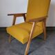 Curly yellow Scandinavian armchair