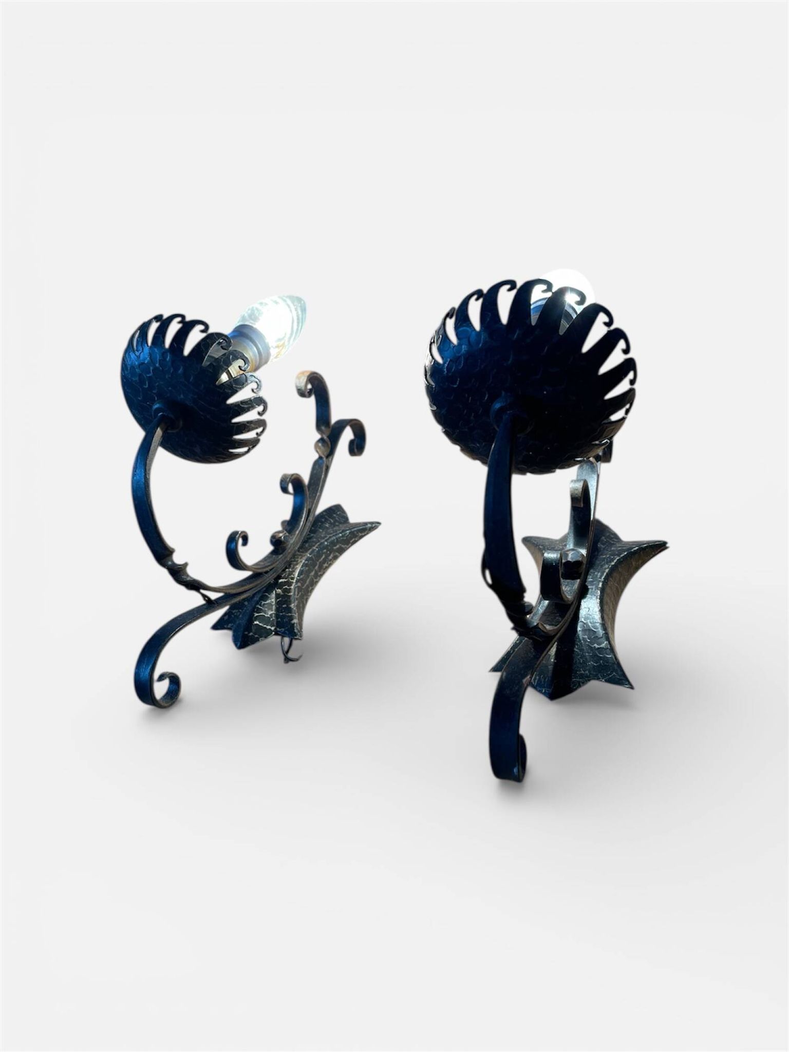 Vintage wrought iron wall lights in rustic gothic style.