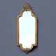 Old small wall mirror in golden resin