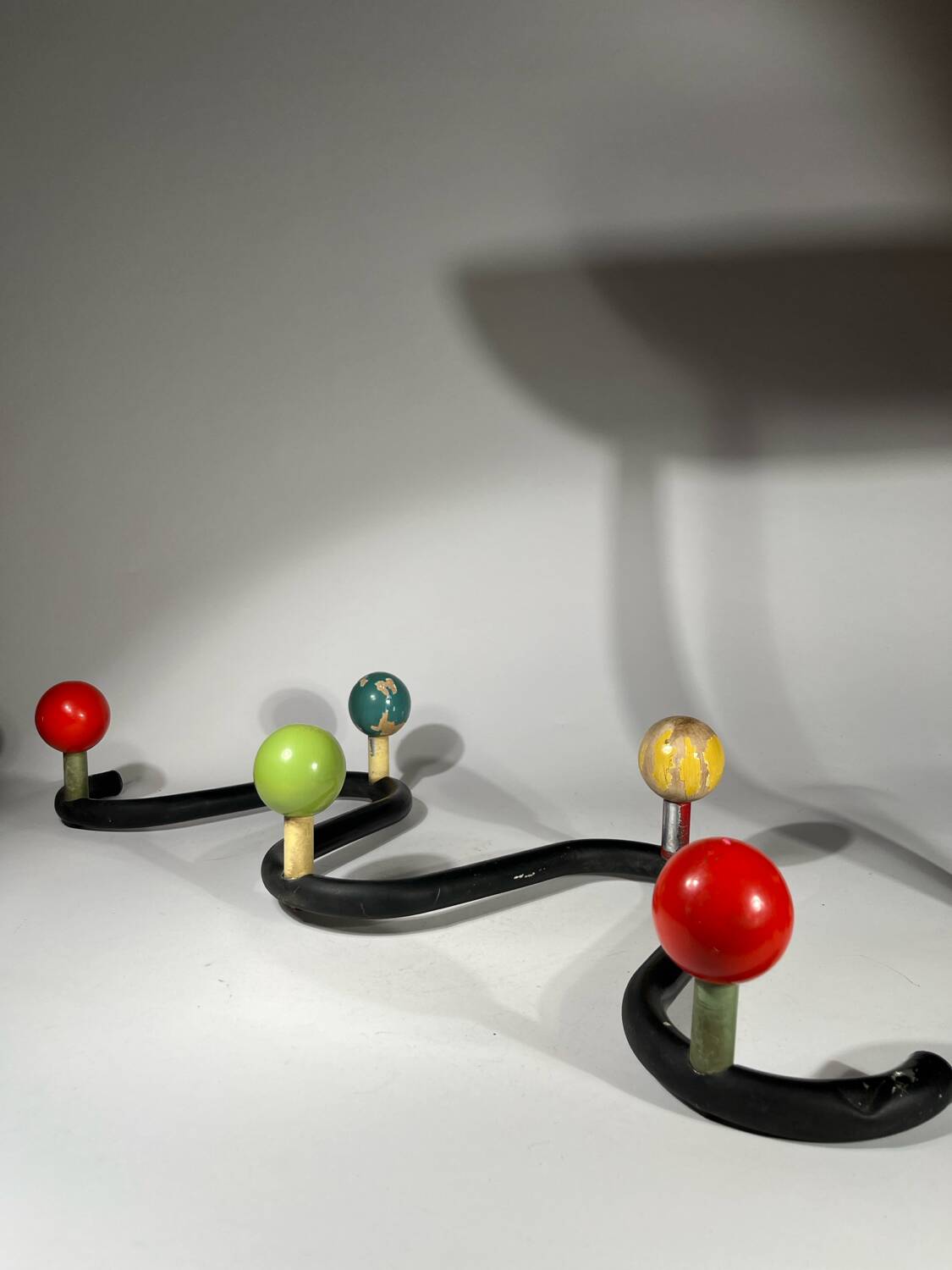 Coat rack in black lacquered metal and colored wooden balls