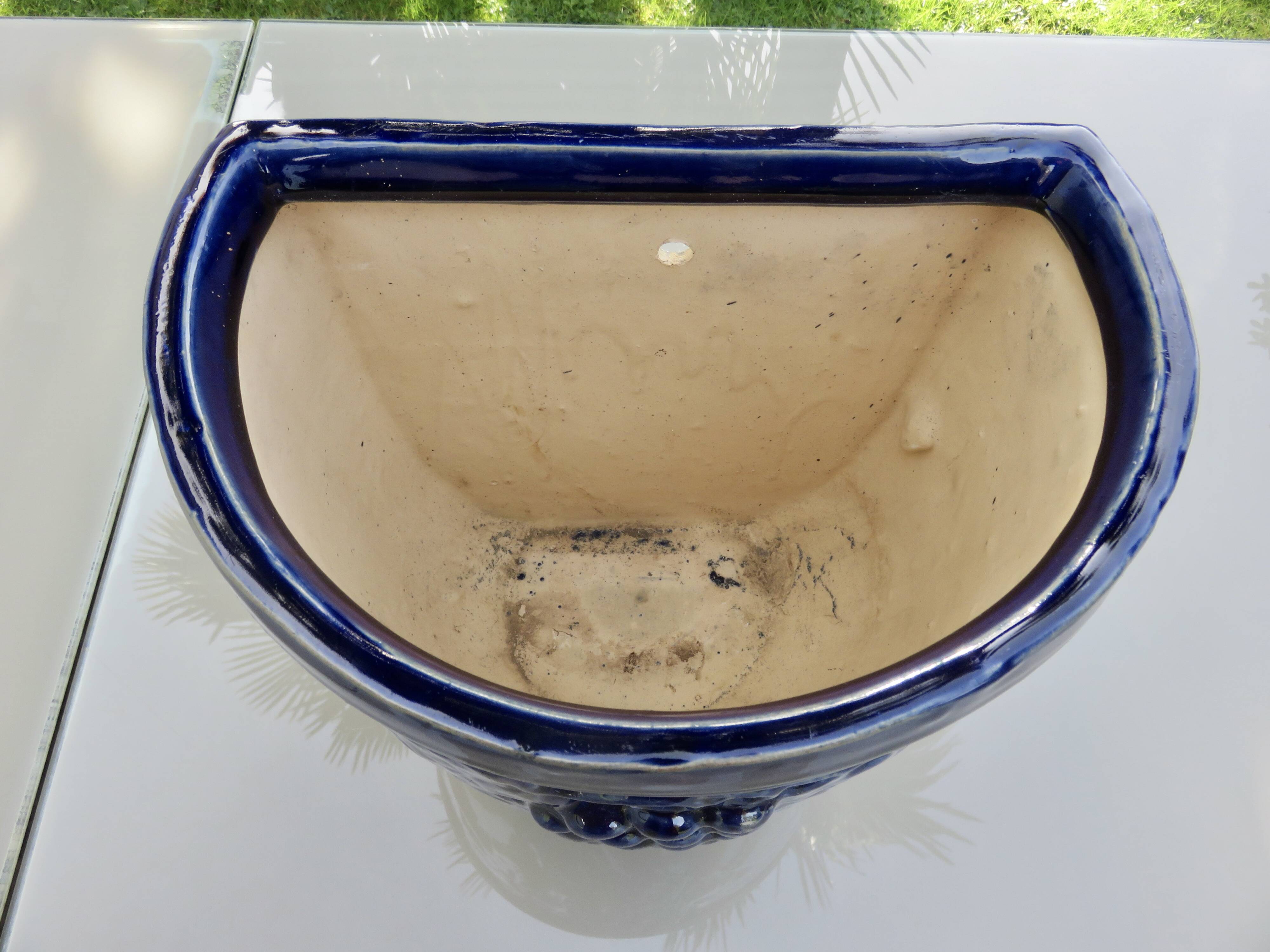 Wall pot in glazed blue terracotta with a grape motif, 1970s.