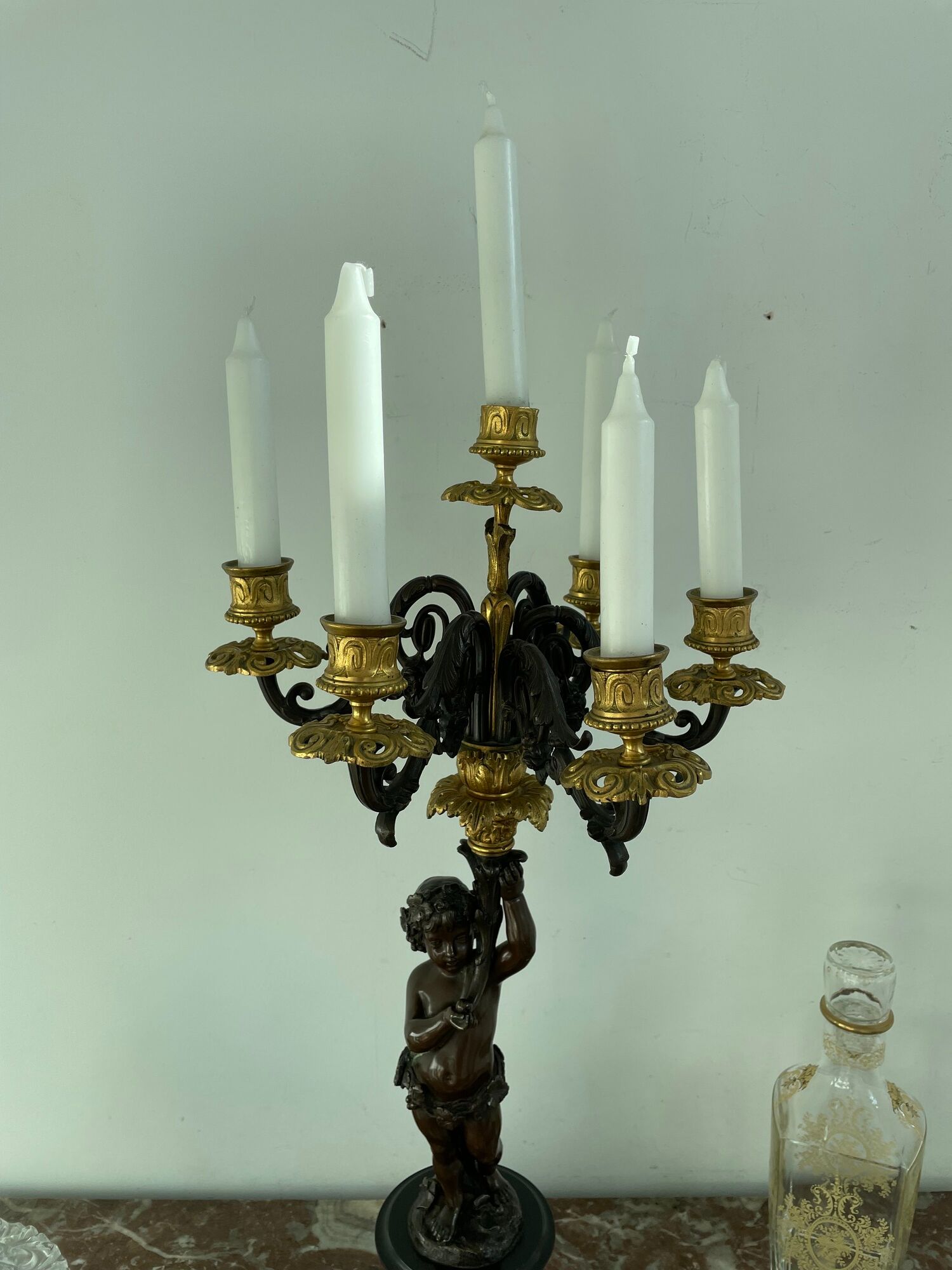 Candelabra with cherub in patinated bronze