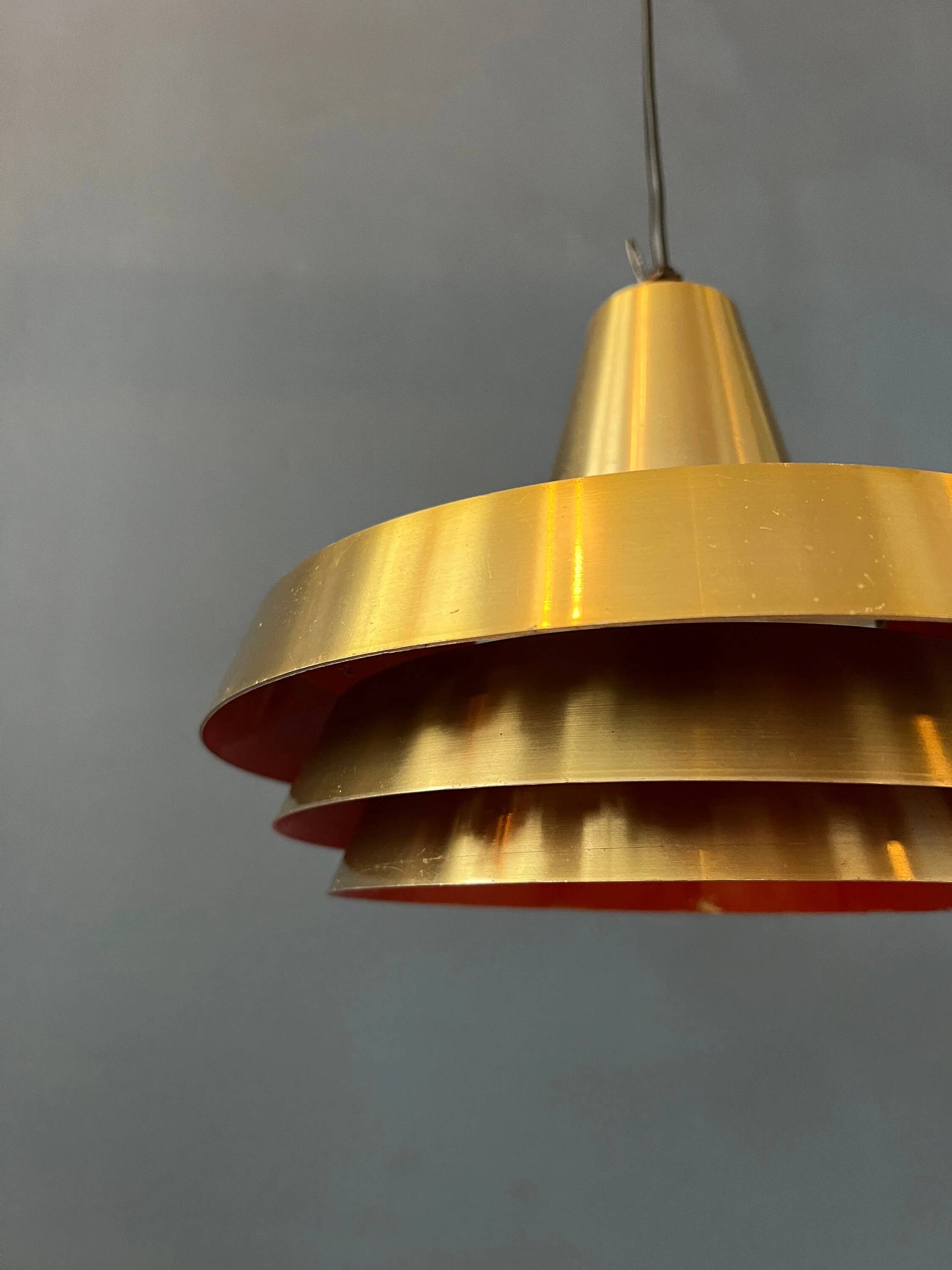 Mid-century Danish style orange brass suspension light.