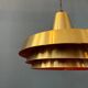 Mid-century Danish style orange brass suspension light.