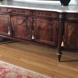 A mahogany buffet varnished with marble and bronze