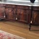 A mahogany buffet varnished with marble and bronze