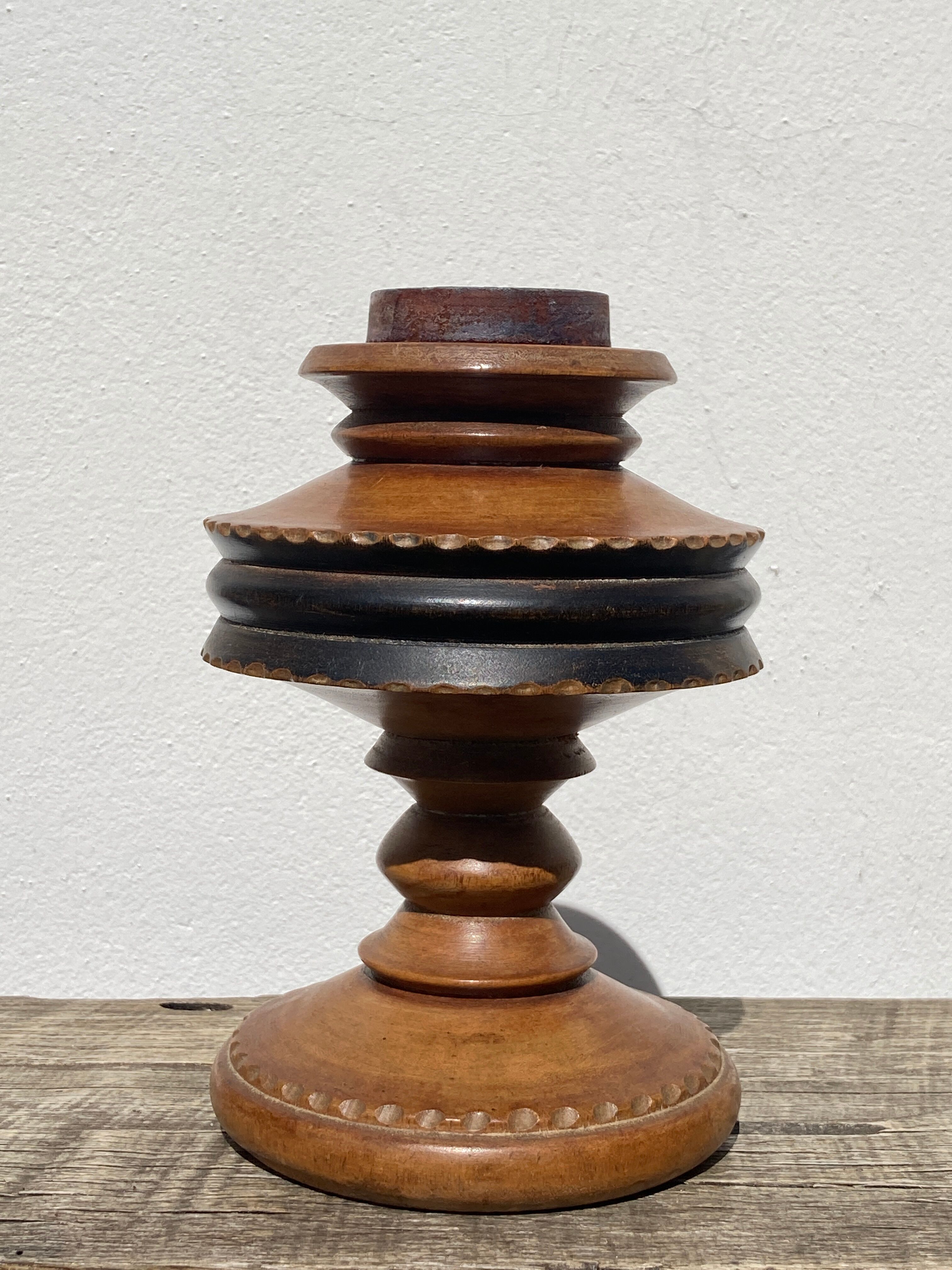 Foot of turned wooden lamp and carved