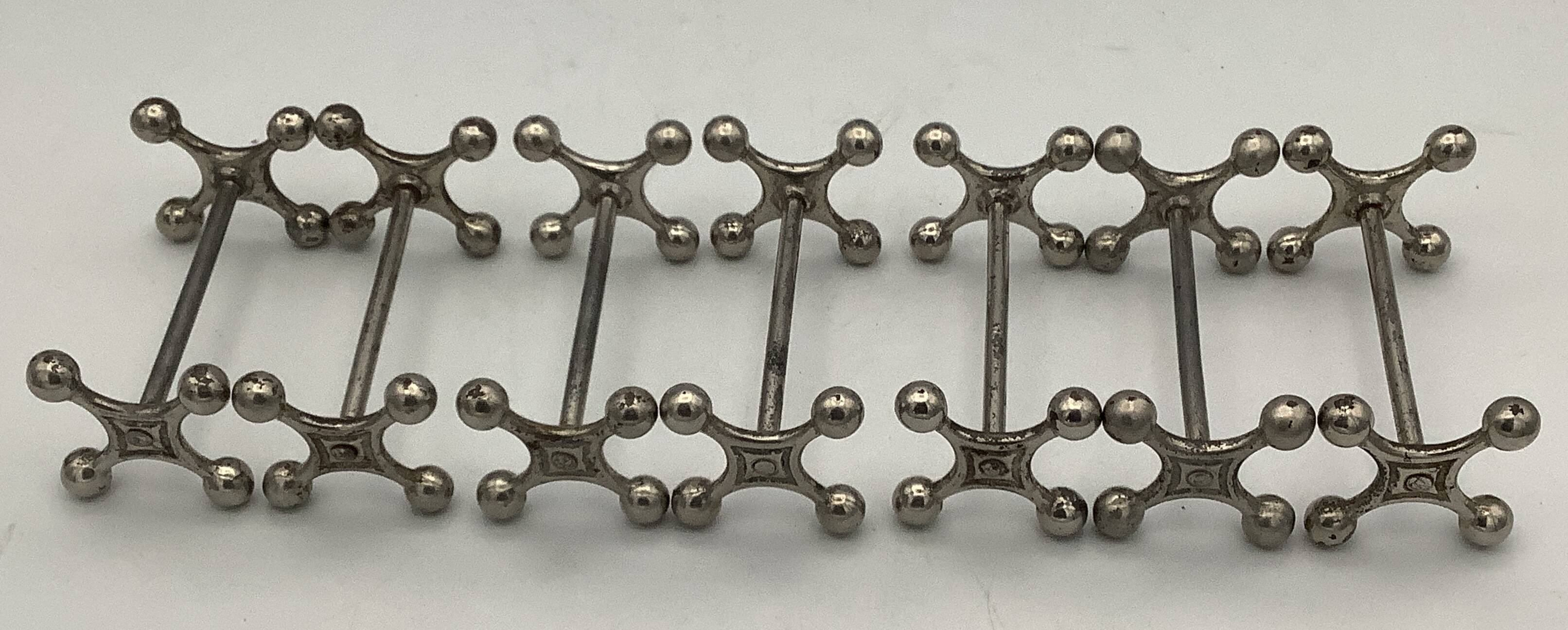 Set of 7 vintage knife rests in the shape of crosses in silver-plated metal.