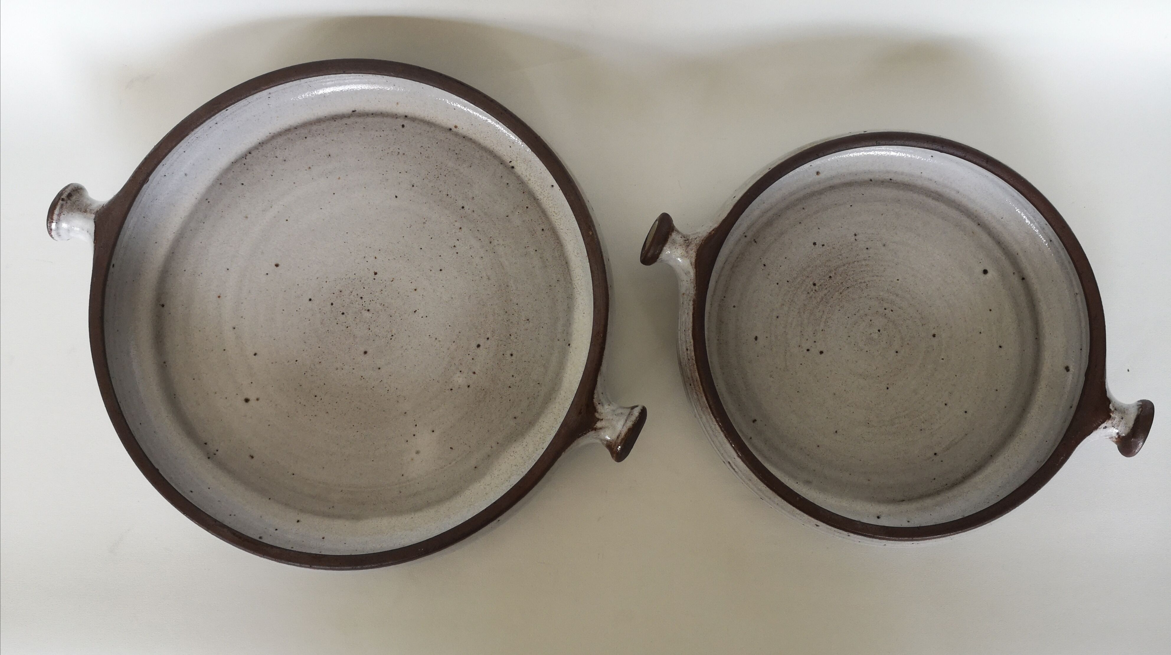 Pair of enamelled sandstone dishes