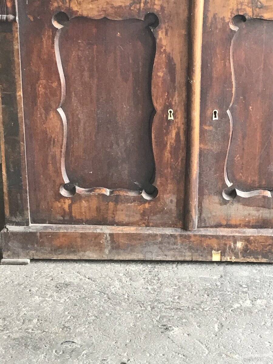 Vintage brown pine dresser with a painted top, moulded panels, and decorative locks.