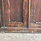 Vintage brown pine dresser with a painted top, moulded panels, and decorative locks.
