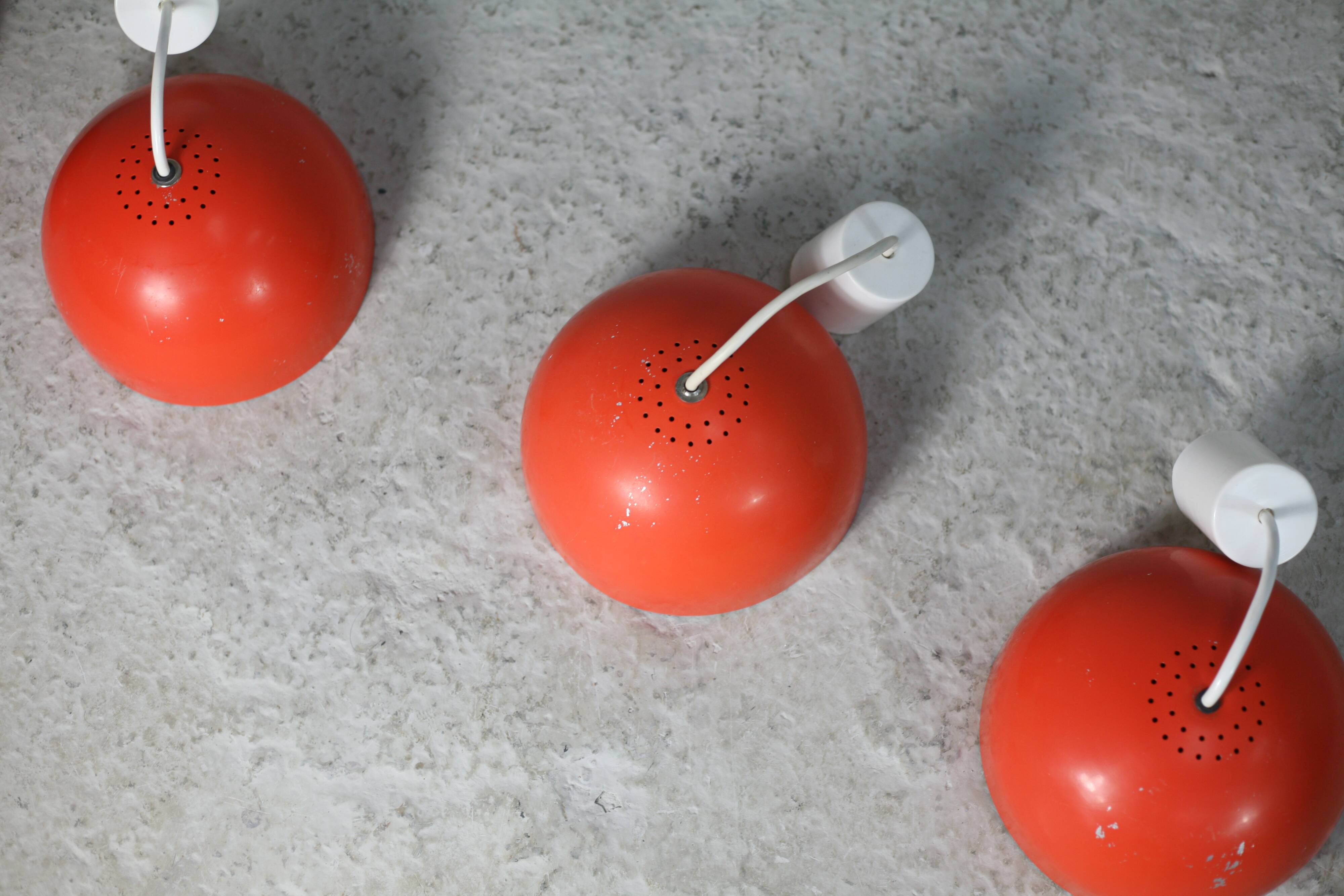 Set of 4 "spring" hanging lamps, orange steel, France, circa 1970