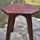 Small Scandinavian side table with wood and pink tiles, with tapered legs.