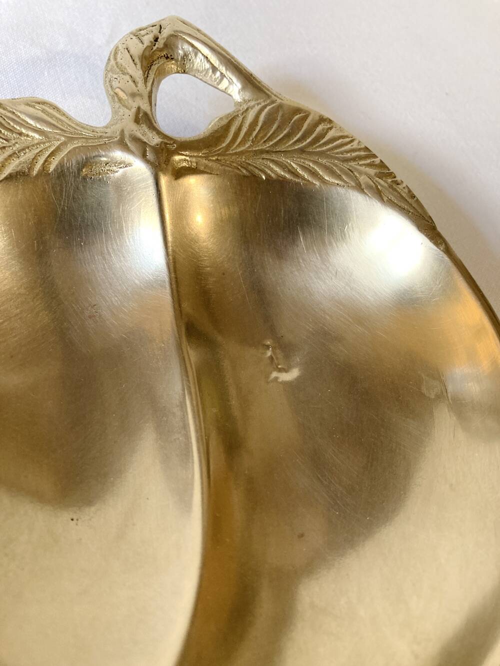 Brass catchall in the shape of an apple.
