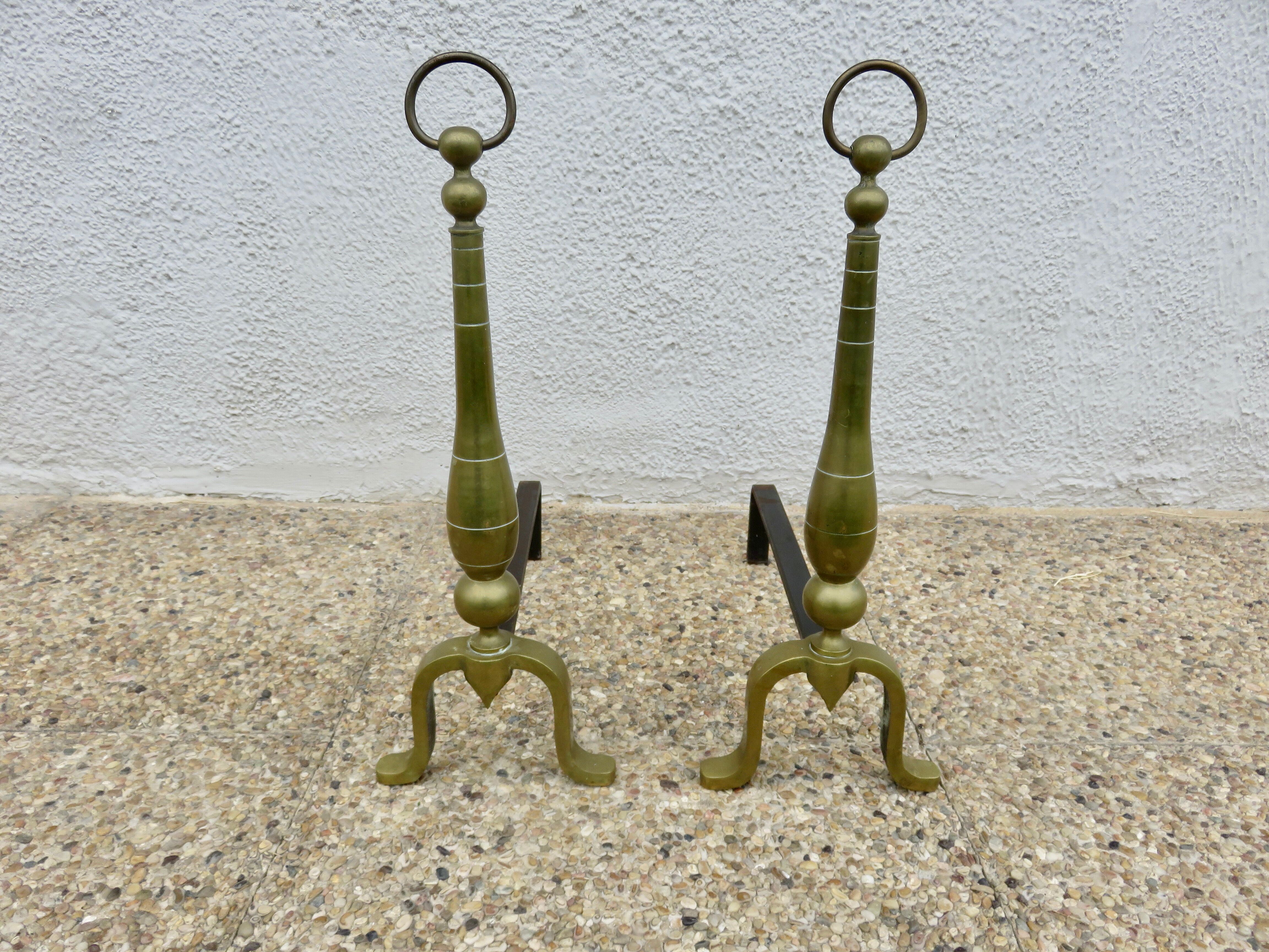 Pair of Neo-classical andirons, in solid bronze, 1920s-1930s.