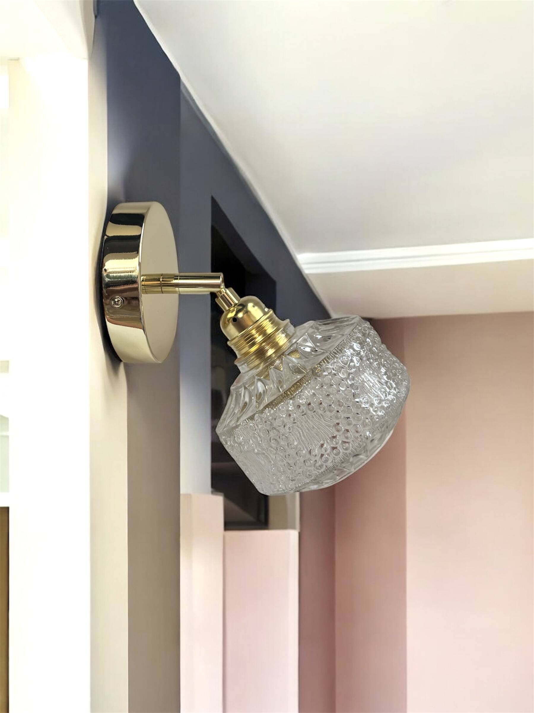 Gold tilting wall light